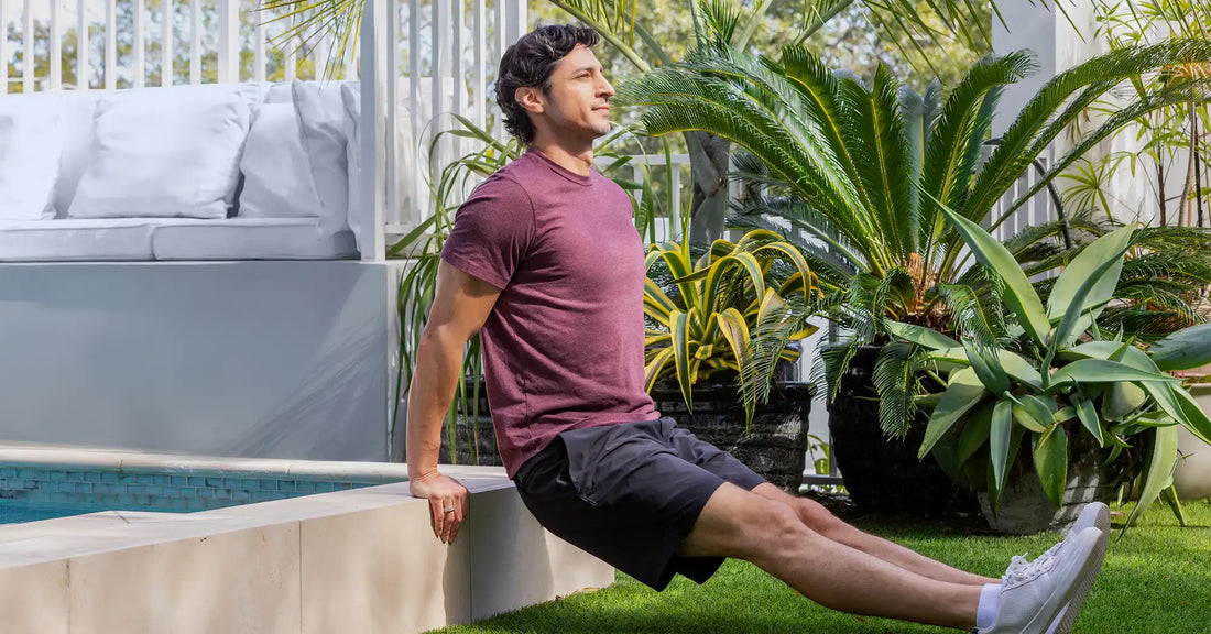 Man performing bodyweight tricep dips outdoors as part of a healthy lifestyle that supports testosterone balance, strength, energy, and overall wellness.