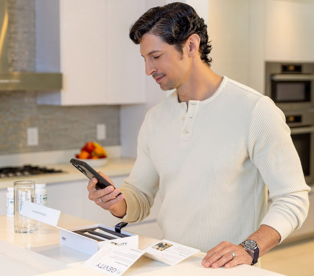Man looking at phone in front of MyGevity test kit