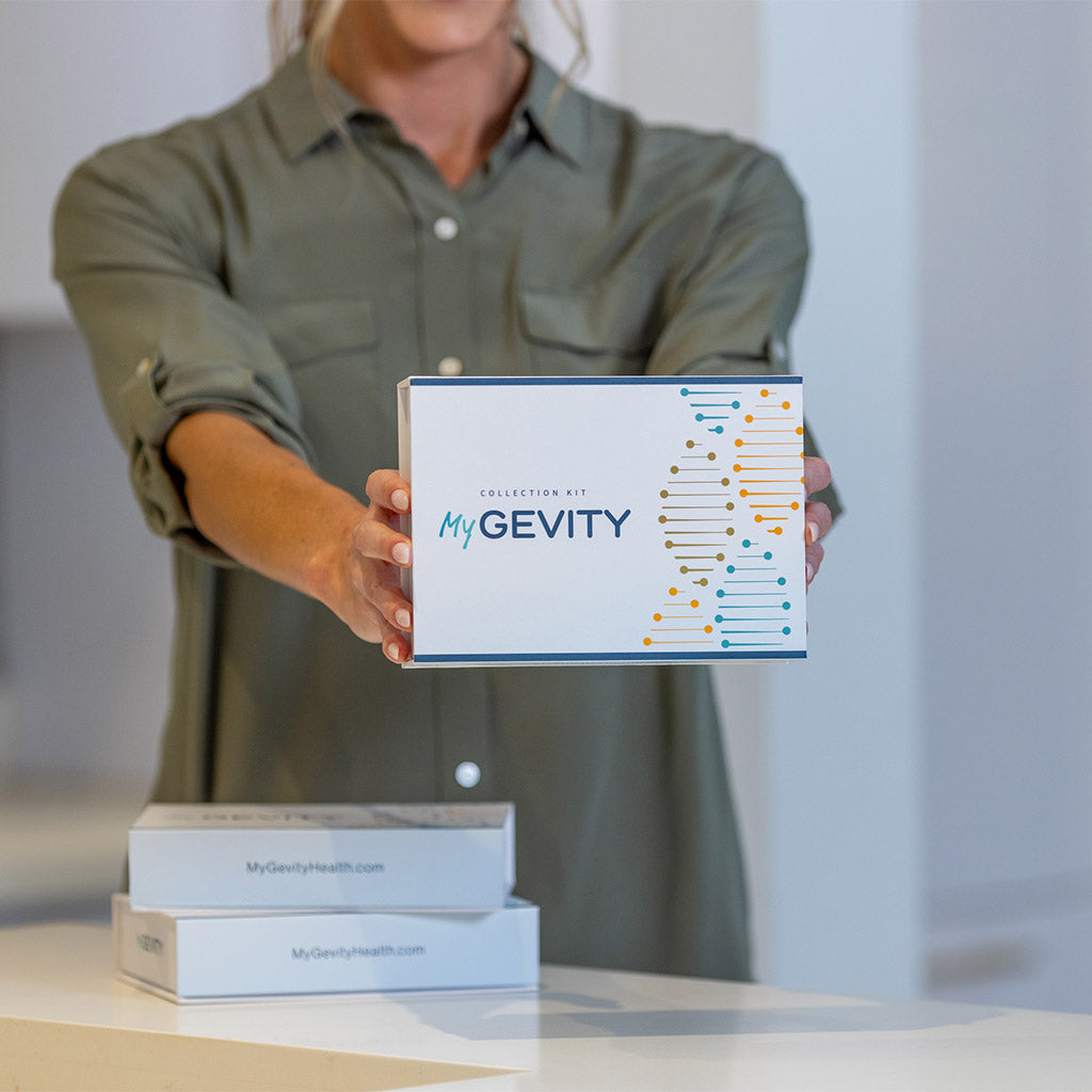 Woman holding box that says Collection Kit MyGevity