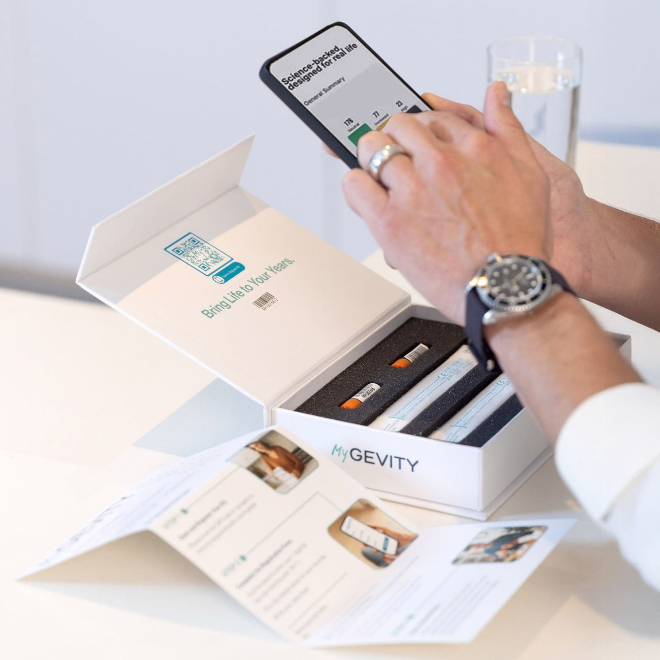 Person using MyGevity app in front of MyGevity test kit